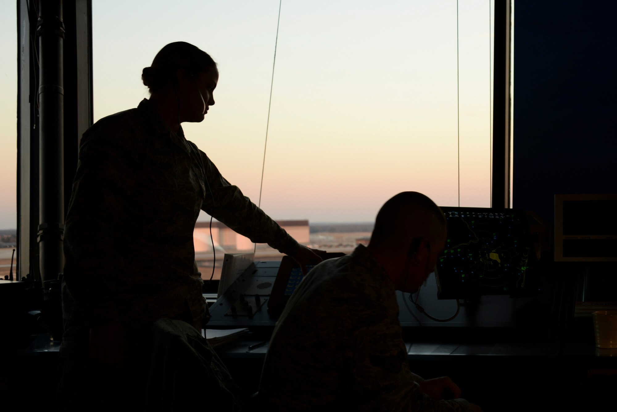 Air traffic controllers from the 305th Operations Support Squadron continuously communicate while on shift to ensure no mishaps occur over Joint Base McGuire-Dix-Lakehurst, N.J., airspace March 11, 2015. Controllers in the control tower fall under three disciplines; local, ground and flight data. (U.S. Air Force photo by Airman 1st Class Tara A. Williamson/Released)