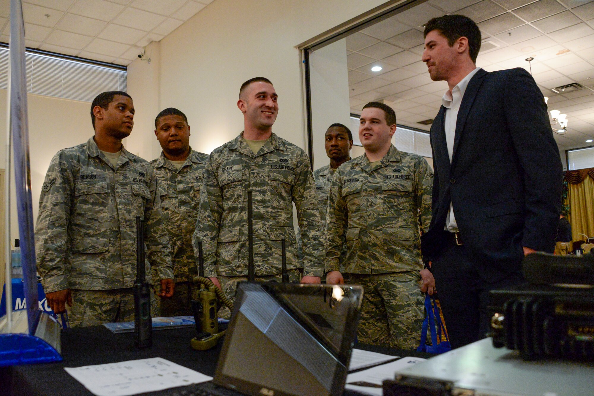 Members of the 87th Civil Engineer Squadron talk to a vendor displaying the latest in their radio technology at the 7th Annual Joint Base McGuire-Dix-Lakehurst Information Technology Expo held at Tommy B's Community Activities Center on JB MDL, N.J., March 11, 2015. Nearly 60 vendors from across the country came to the joint base to share the technological advancements to the joint base community. (U.S. Air Force photo by Airman 1st Class Tara A. Williamson/Released)