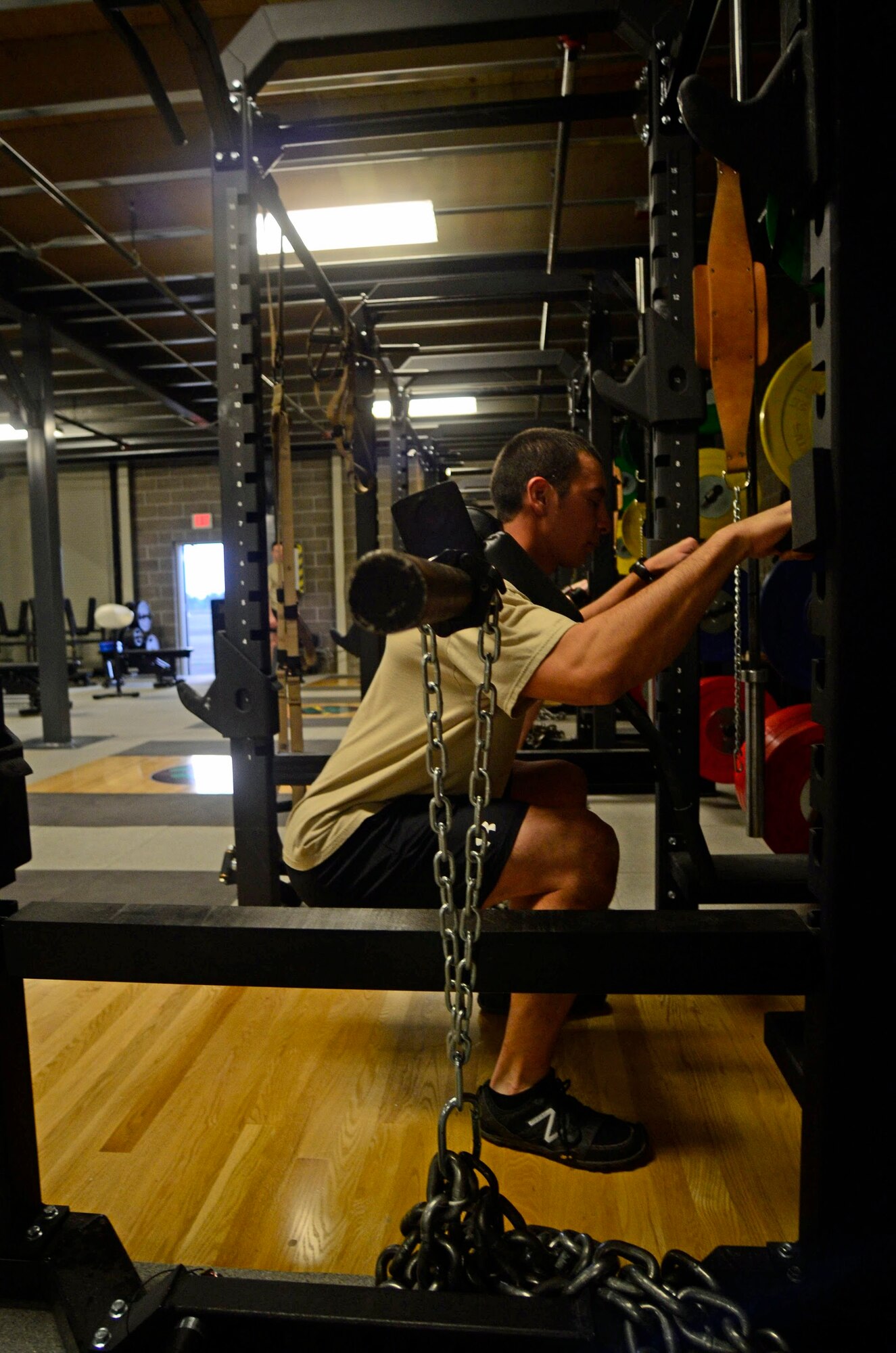 A member of the 22nd Special Tactics Squadron readies himself to lift weights Mar. 2, 2015, at Joint Base Lewis McChord, Wash.  Several weight racks were one of the upgrades when the 22 STS provided space for a new training facility for the unit's strength and conditioning coach, Dan Clemons. (Northwest Guardian/Dean Siemon)