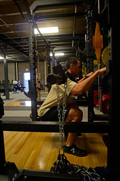 A member of the 22nd Special Tactics Squadron readies himself to lift weights Mar. 2, 2015, at Joint Base Lewis McChord, Wash.  Several weight racks were one of the upgrades when the 22 STS provided space for a new training facility for the unit's strength and conditioning coach, Dan Clemons. (Northwest Guardian/Dean Siemon)