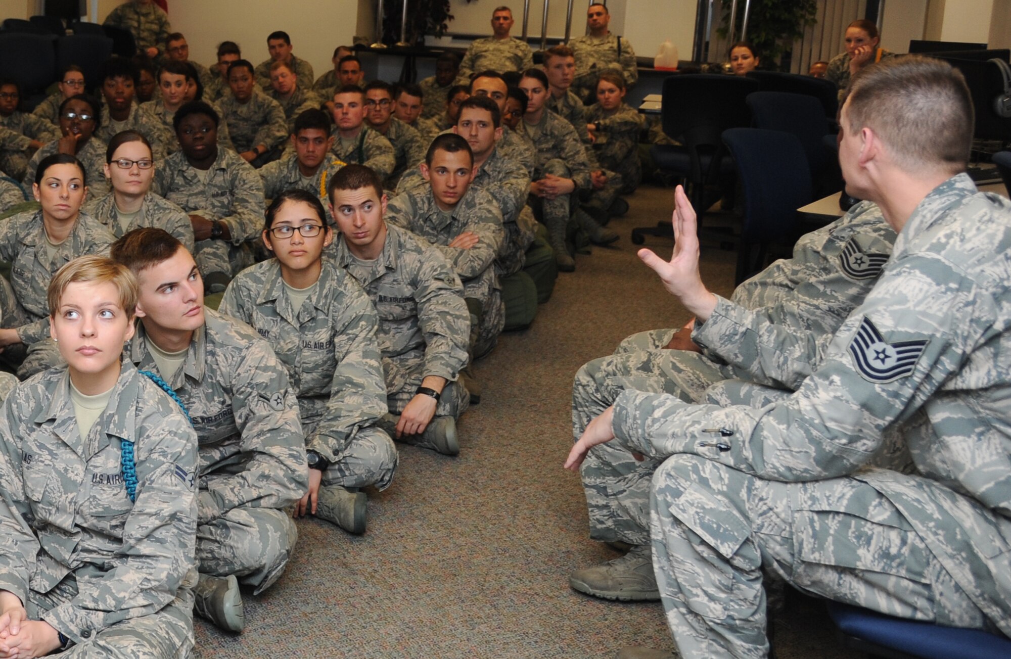 Tech. Sgt. Timothy Martinez, 335th Training Squadron weather forecaster apprentice course instructor, provides a pre-deployment briefing to 335th Training Squadron Airmen during an “Introduction to Mobility” training day for non-prior service Airmen March 13, 2015, at Connor Manor, Keesler Air Force Base, Miss.  Airmen participated in pre-deployment training scenarios such as: going through a mobility processing line, administering self-aid and buddy care, reviewing the steps for chemical warfare gear and receiving a pre-deployment briefing.  The training was conducted to better prepare Keesler’s Airmen for deployment operations. (U.S. Air Force photo by Kemberly Groue)