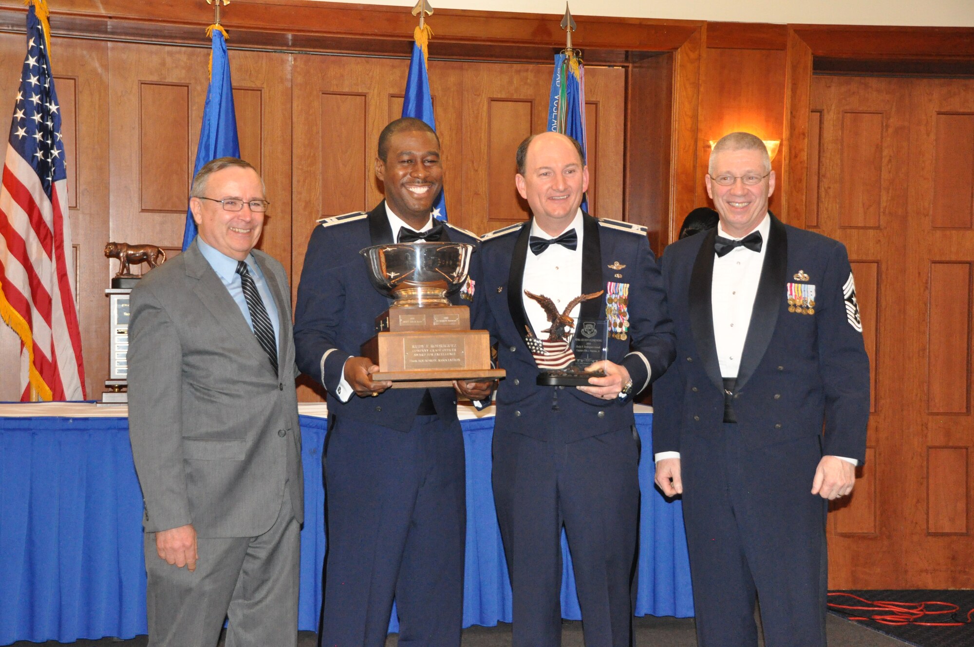 Capt. Ellis Haynes, 459th Equal Opportunity Office, wins the 459th Wing Association's Rudy F. Rodriguez Company Grade Officer Award for Excellence at the 459 ARW Annual Awards Banquet on Saturday, March 7, 2015. He is flanked by association president, Mr. Tim McConnell, the wing commander, Col. Thomas Smith, and the wing command chief, Chief Master Sgt. Tim Huffman. (Air Force Photo / SrA Kristin Kurtz)
