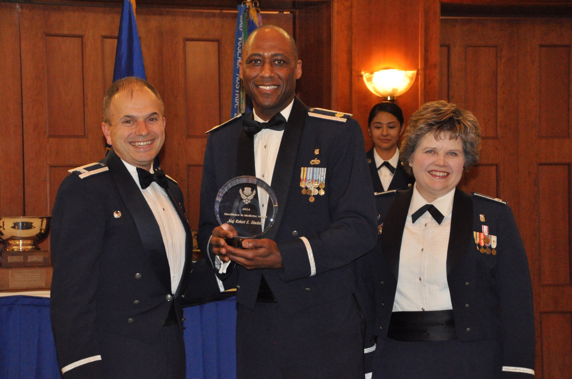 Maj. Robert Sinclair, 459th Aeromedical Staging Squadron, wins the Medical Group Excellence Award at the 459 ARW Annual Awards Banquet on Saturday, March 7, 2015. He is flanked by his commander, Col. Oba Vincent, 459 ASTS, and Col. Christine Barber, 459 AMDS commander. (Air Force Photo / SrA Kristin Kurtz)
