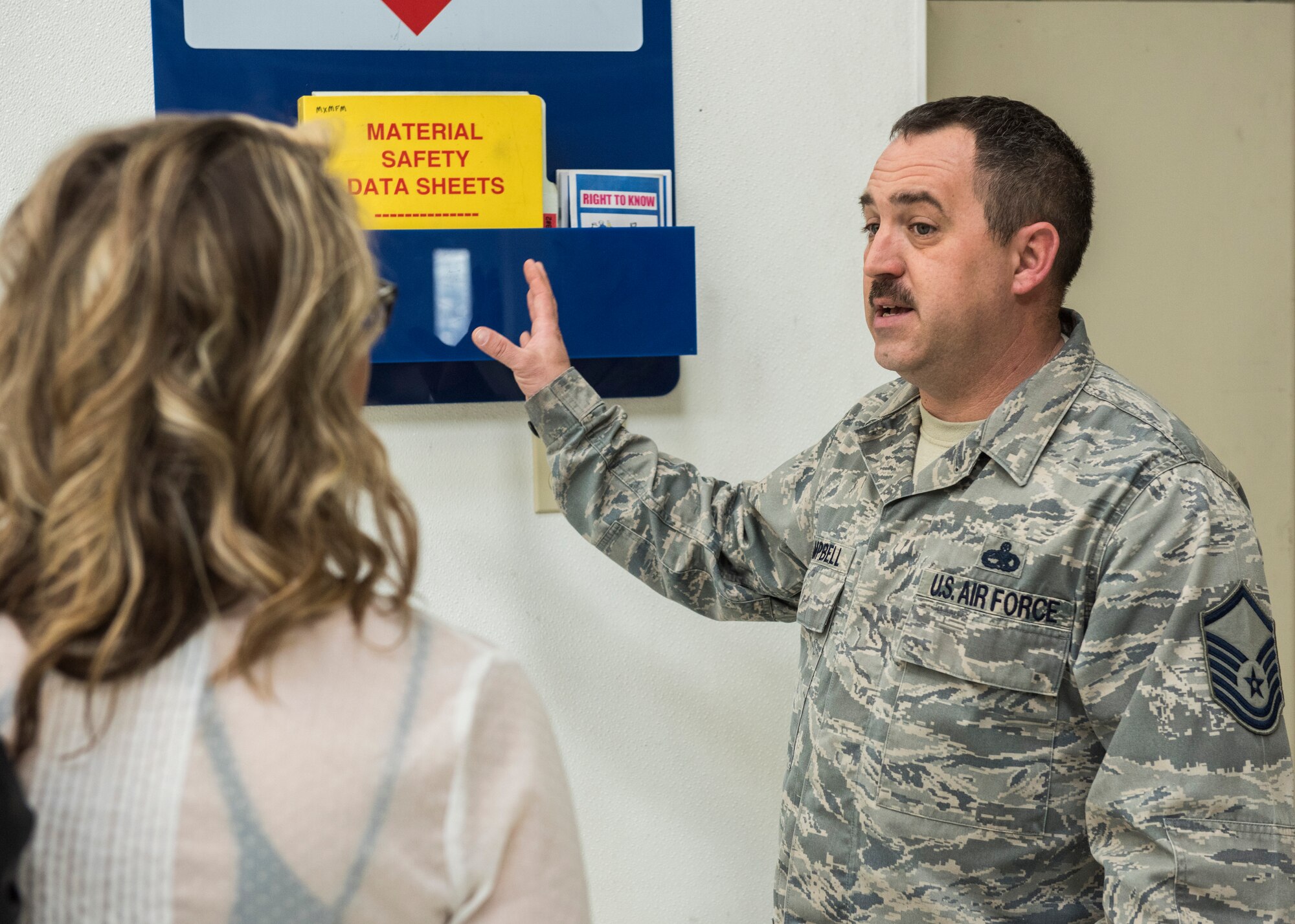 Master Sgt. Michael Campbell, 366th Equipment Maintenance Squadron structural maintenance shop chief, explains the processes used to document safety hazards through Material Safety Data Sheets at Mountain Home Air Force Base, Idaho, March 10, 2015. Idaho Power visited the base to better understand some of the ways MHAFB adheres to safety regulations. (U.S. Air Force photo by Airman Connor J. Marth/Released)