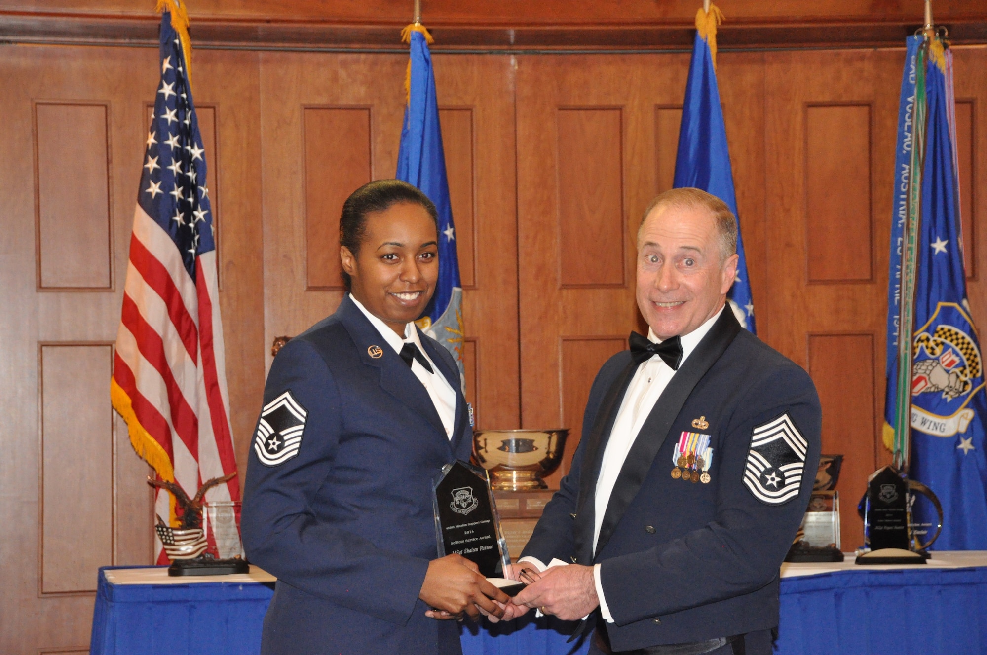 Chief Master Sergeant Keith Cockey, 459th Mission Support Group, presents the 459 MSG Selfless Service Award to Master Sgt. Shaleen Parson, 459th Force Support Squadron, at the 459 ARW Annual Awards Banquet on Saturday, March 7, 2015. (Air Force Photo / SrA Kristin Kurtz)

