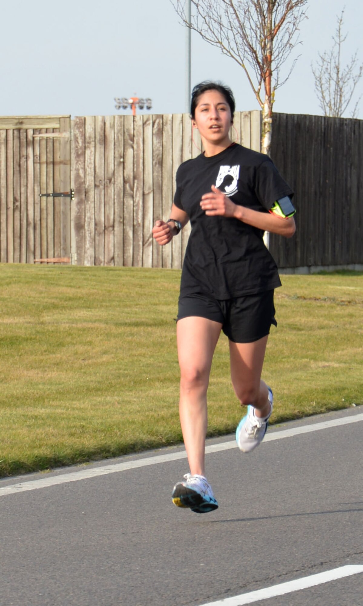 U.S. Air Force Staff Sgt. Jessica Garcia, 100th Security Forces Squadron combined controller, is the first female across the finish line in the monthly wing run March 13, 2015, near the Hardstand Fitness Center on RAF Mildenhall, England. Garcia completed the run at 20 minutes, 40 seconds. (U.S. Air Force photo by Gina Randall/Released)

