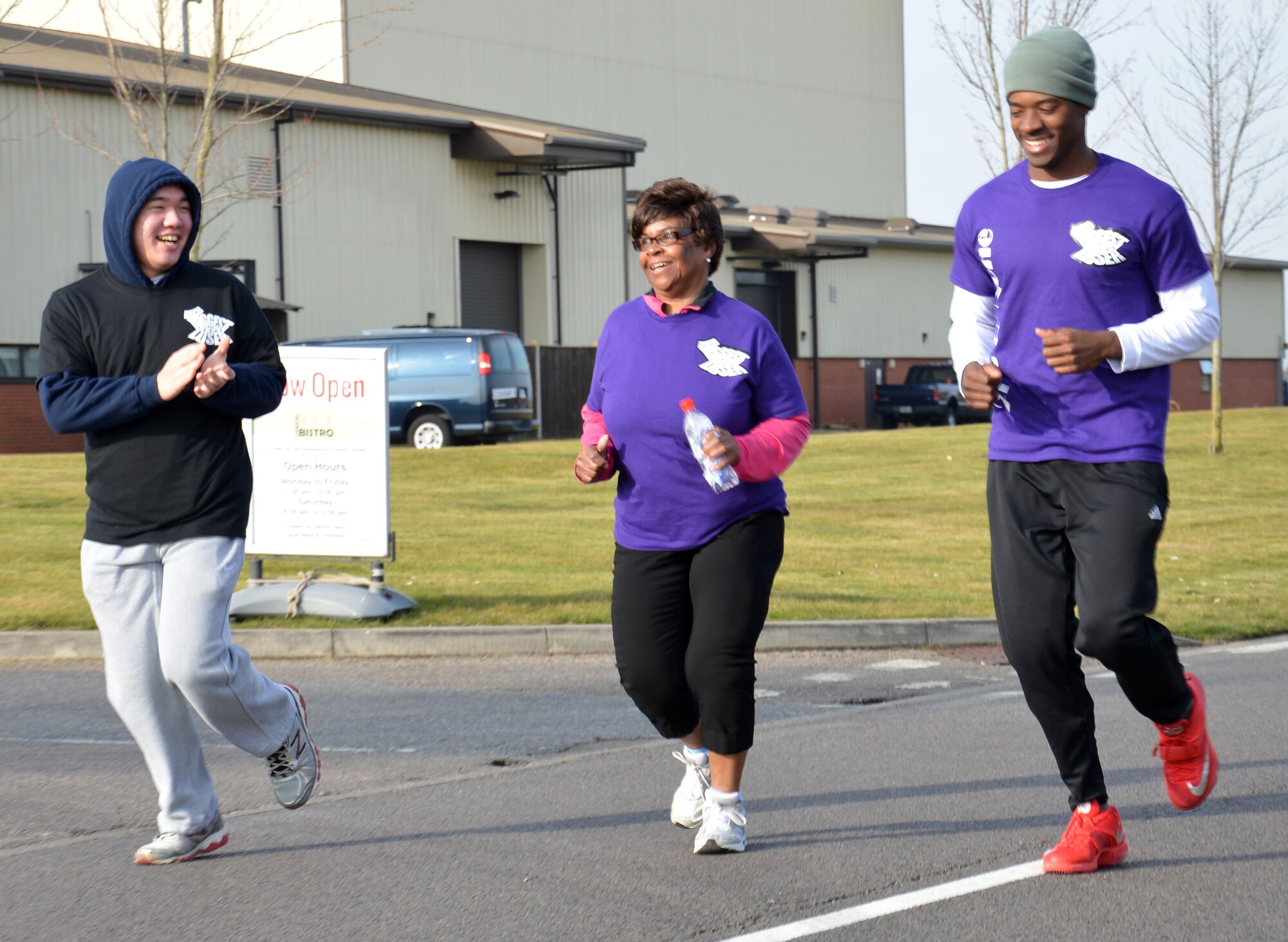Members of “The Biggest Loser” competition encourage each other over the finish line in the monthly wing run March 13, 2015, near the Hardstand Fitness Center on RAF Mildenhall, England. The run served as the finale to the biggest loser competition, designed to encourage people to lose weight by eating healthy foods and exercising. (U.S. Air Force photo by Gina Randall/Released)