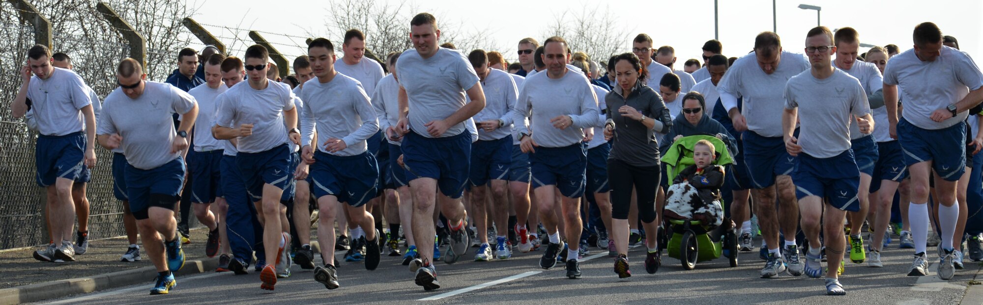 Team Mildenhall members take part in the monthly wing run March 13, 2015, near the Hardstand Fitness Center on RAF Mildenhall, England. The monthly 5k run encourages morale and camaraderie throughout the base through exercise and healthy competition. (U.S. Air Force photo by Gina Randall/Released)