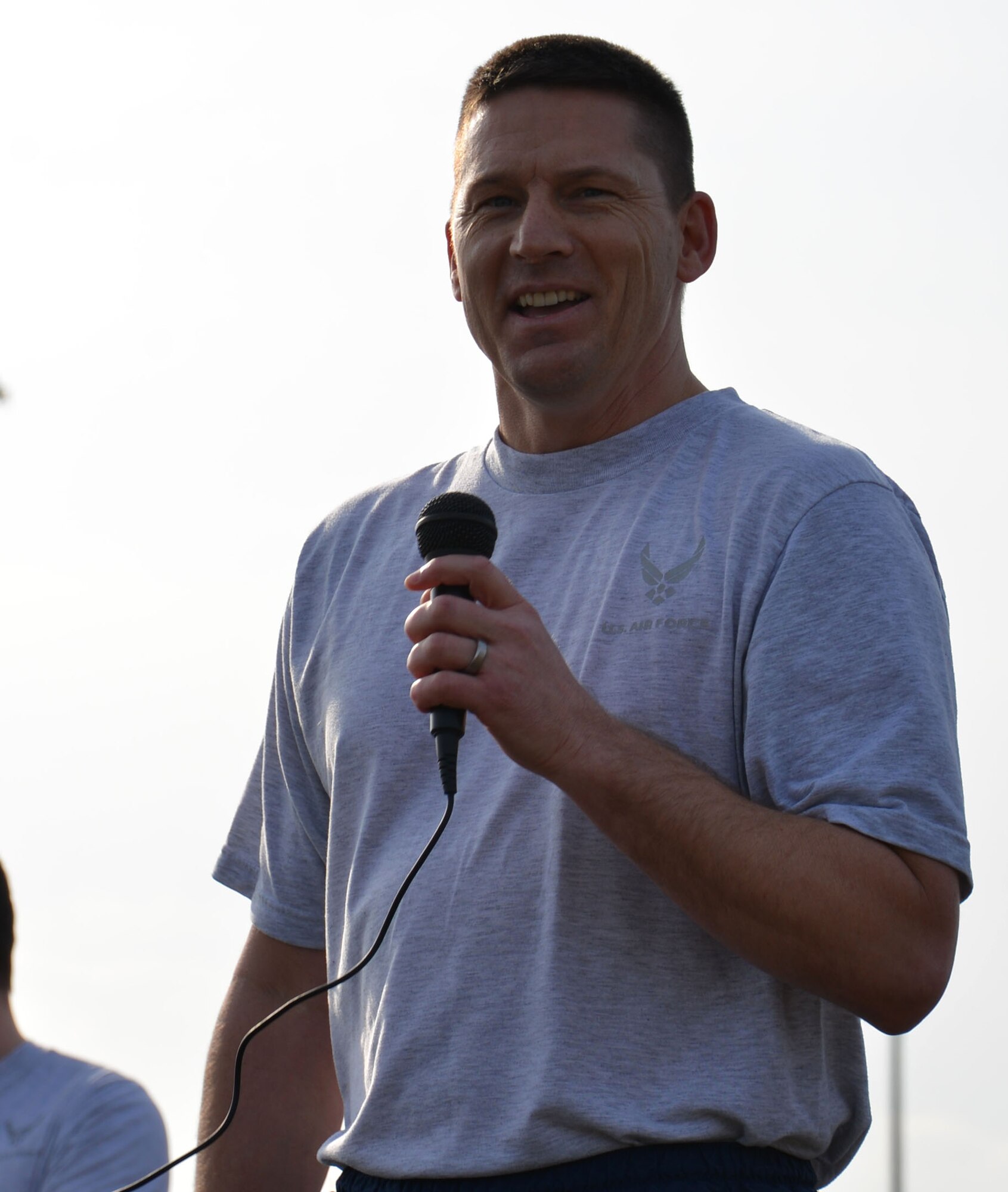 U.S. Air Force Chief Master Sgt. Tracy Jones, 100th Air Refueling Wing command chief, encourages Team Mildenhall members as they prepare for a monthly wing run March 13, 2015, near the Hardstand Fitness Center on RAF Mildenhall, England. Team Mildenhall leadership came out to wish their Airmen a good run and a great weekend. (U.S. Air Force photo by Gina Randall/Released)