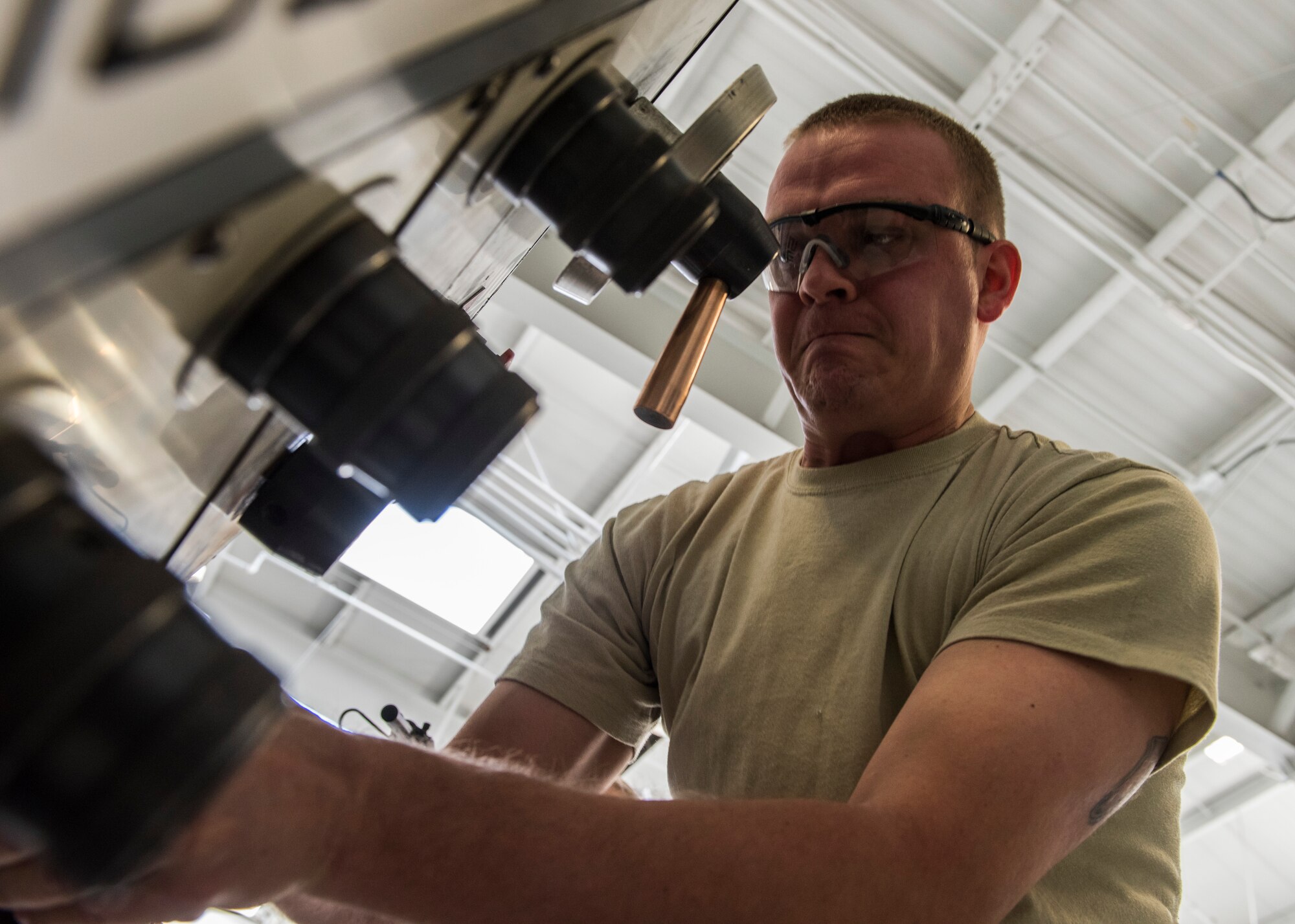 Staff Sgt. Andrew Walker, 366th Equipment Maintenance Squadron metals technician, operates a lathe at Mountain Home Air Force Base, Idaho, March 10, 2015.  The lathe is one of the many machines the 366th EMS uses to create parts for aircraft on base. (U.S. Air Force photo by Airman Connor J. Marth/Released)