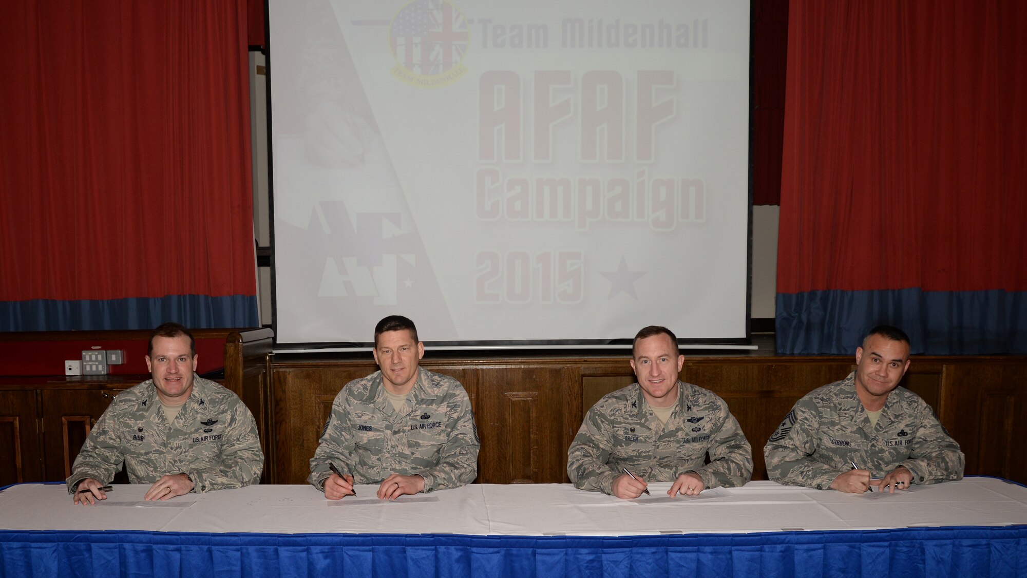 Team Mildenhall leadership signs their 2015 Air Force Assistance Fund pledges during the AFAF kickoff breakfast March 9, 2015, at the Galaxy Club on RAF Mildenhall, England. The AFAF is an annual fundraiser that provides funds for Airmen in need of financial assistance. The campaign supports four charities dedicated to caring for Airmen from induction through retirement and beyond. (U.S. Air Force photo by Airman 1st Class Jonathan Light/Released)