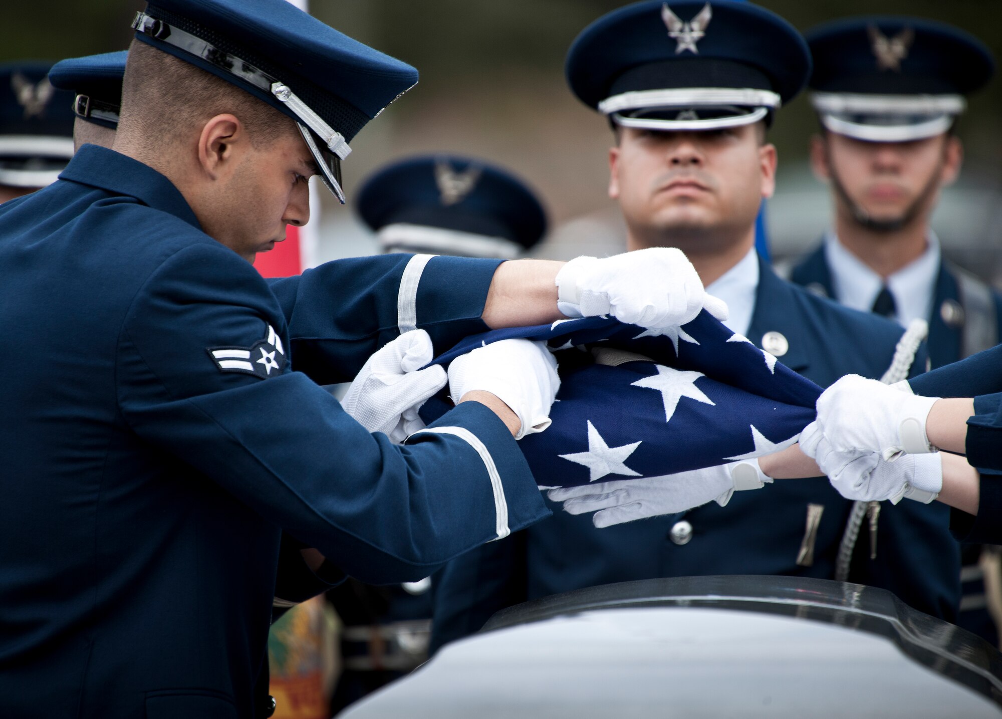 Airman 1st Class Michael Campbell, 96th Logistics Readiness Squadron, tucks in the last bit of the American flag at the Honor Guard graduation ceremony March 4 at Eglin Air Force Base, Fla. Approximately 12 new Airmen graduated from the 80-plus-hour course. The graduation performance is a full military honors funeral to include flag detail, rifle volley, pall bearers and bugler. (U.S. Air Force photo/Samuel King Jr.)