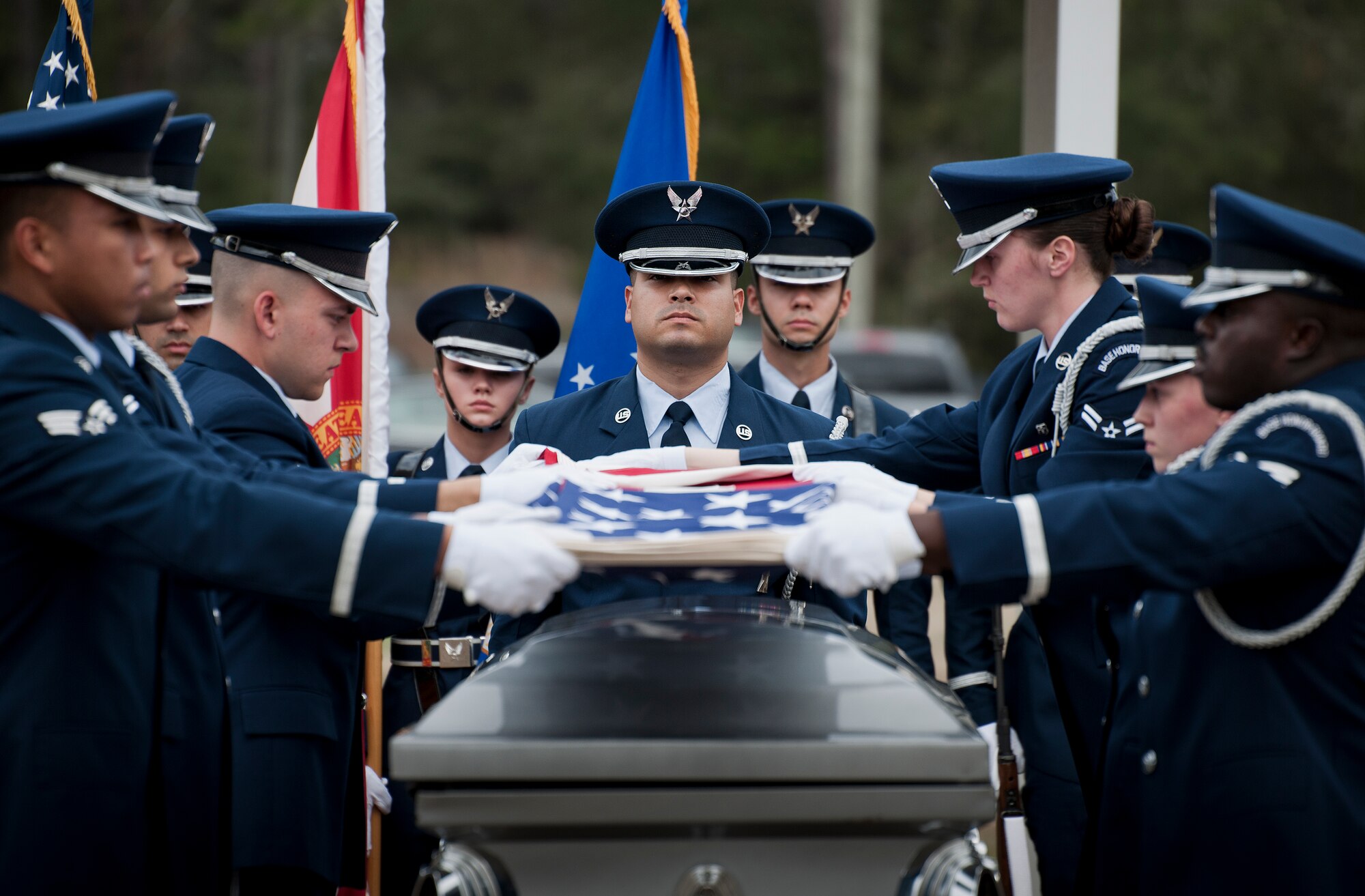New honor guard members prepare to fold the flag at the Honor Guard graduation ceremony March 4 at Eglin Air Force Base, Fla. Approximately 12 new Airmen graduated from the 80-plus-hour course. The graduation performance is a full military honors funeral to include flag detail, rifle volley, pall bearers and bugler. (U.S. Air Force photo/Samuel King Jr.)