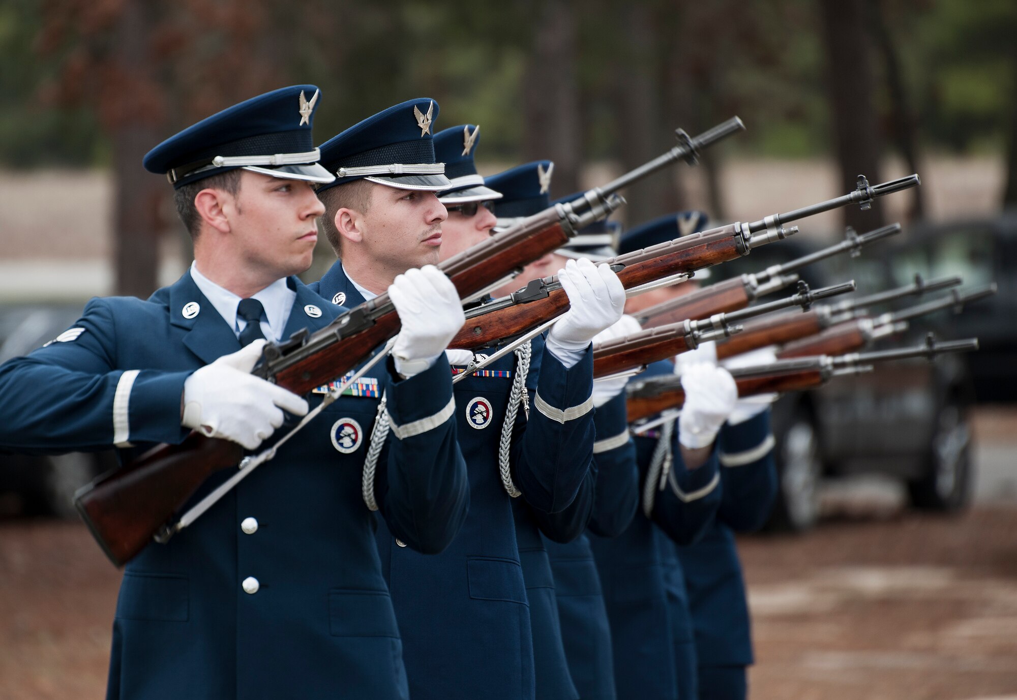 Members of the Eglin Air Force Base Honor Guard perform a rifle volley during the unit’s graduation ceremony March 4.  Approximately 12 new Airmen graduated from the 80-plus-hour course. The graduation performance includes flag detail, rifle volley, pall bearers and bugler for friends, family and unit commanders. (U.S. Air Force photo/Samuel King Jr.)