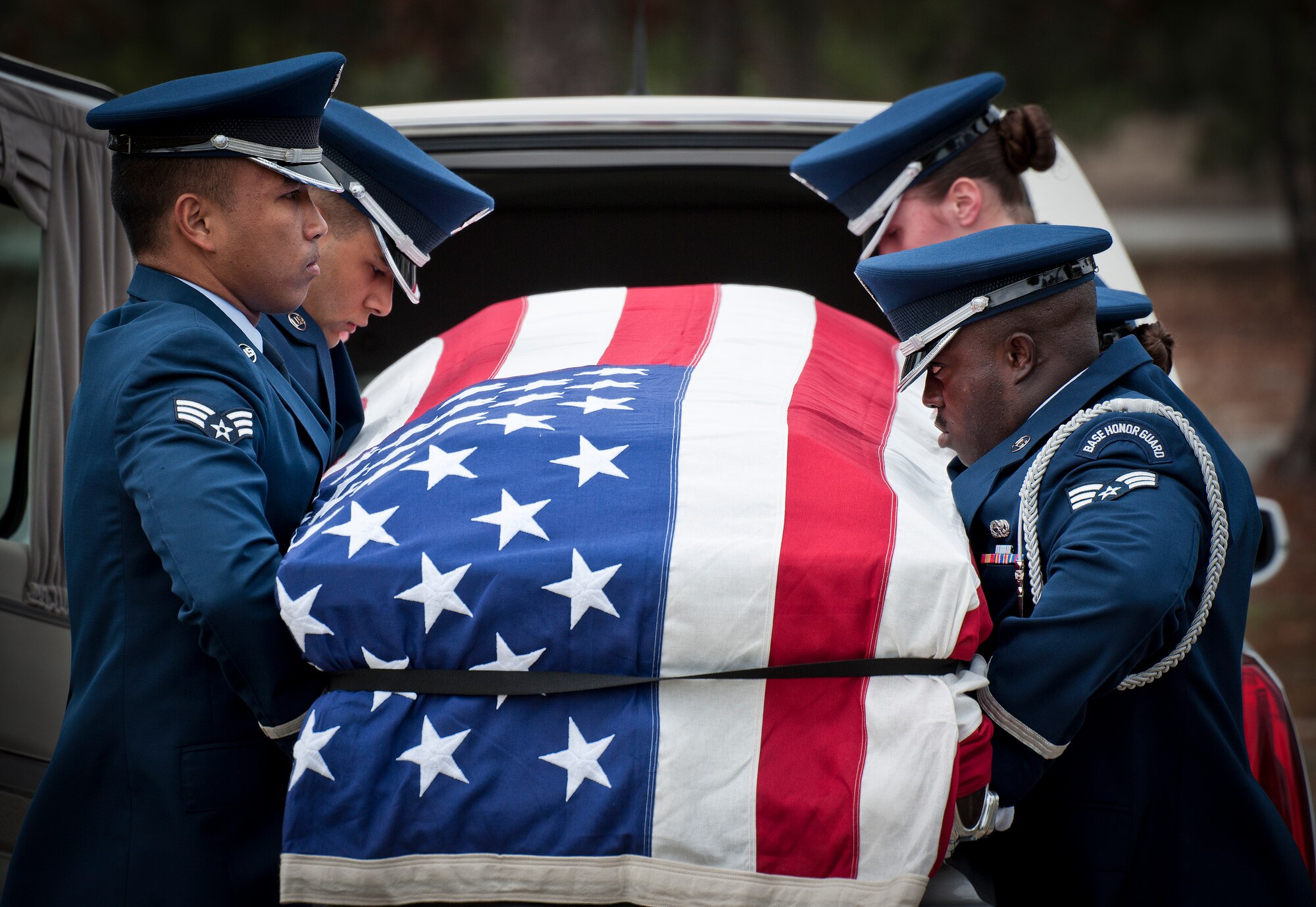 Members of the Eglin Air Force Base Honor Guard remove a casket from a hearse during the unit’s graduation ceremony March 4. Approximately 12 new Airmen graduated from the 80-plus-hour course. The graduation performance includes flag detail, rifle volley, pall bearers and bugler for friends, family and unit commanders. (U.S. Air Force photo/Samuel King Jr.)