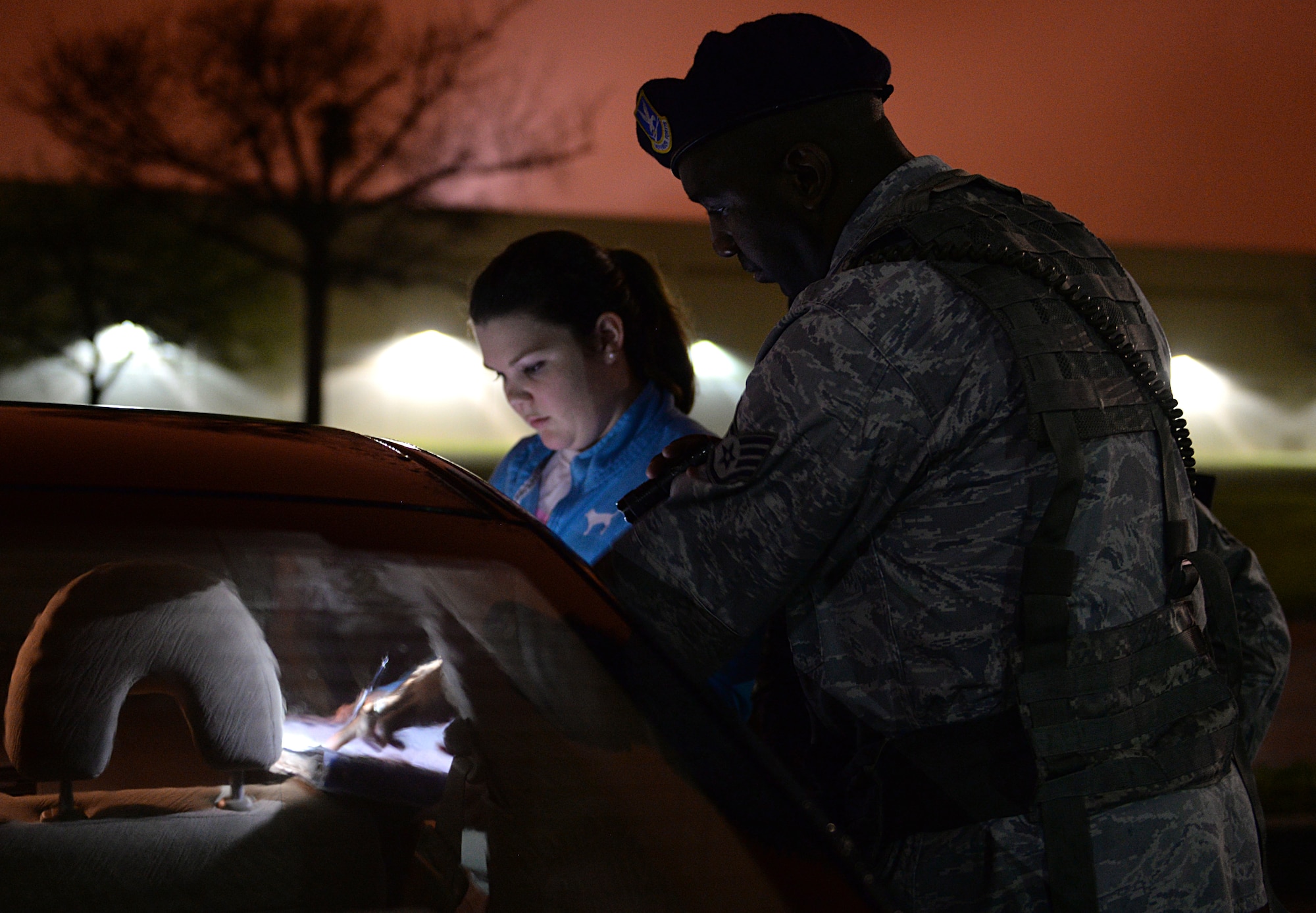 Staff Sgt. Jason Moore, 81st Security Forces patrolman, helps a car accident victim write a statement March 12, 2015, Keesler Air Force Base, Miss. 81st SFS Airmen perform multiple roles to keep members of Keesler safe, ranging from identification checks at base entrances to searching for explosives and narcotics with military working dogs. (U.S. Air Force photo by Senior Airman Holly Mansfield)