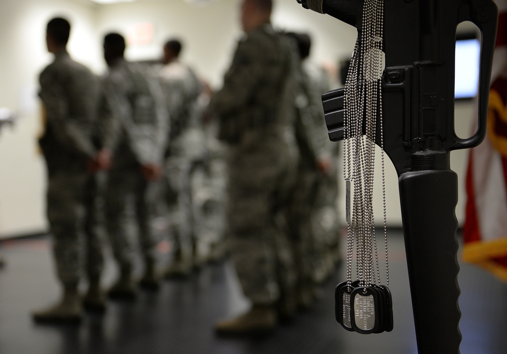Dog tags representing fallen security forces Airmen hang on a fallen heroes memorial in the guard mount room in the security forces building March 12, 2015, Keesler Air Force Base, Miss. 81st SFS Airmen perform multiple roles to keep members of Keesler safe, ranging from identification checks at base entrances to searching for explosives and narcotics with military working dogs. (U.S. Air Force photo by Senior Airman Holly Mansfield)