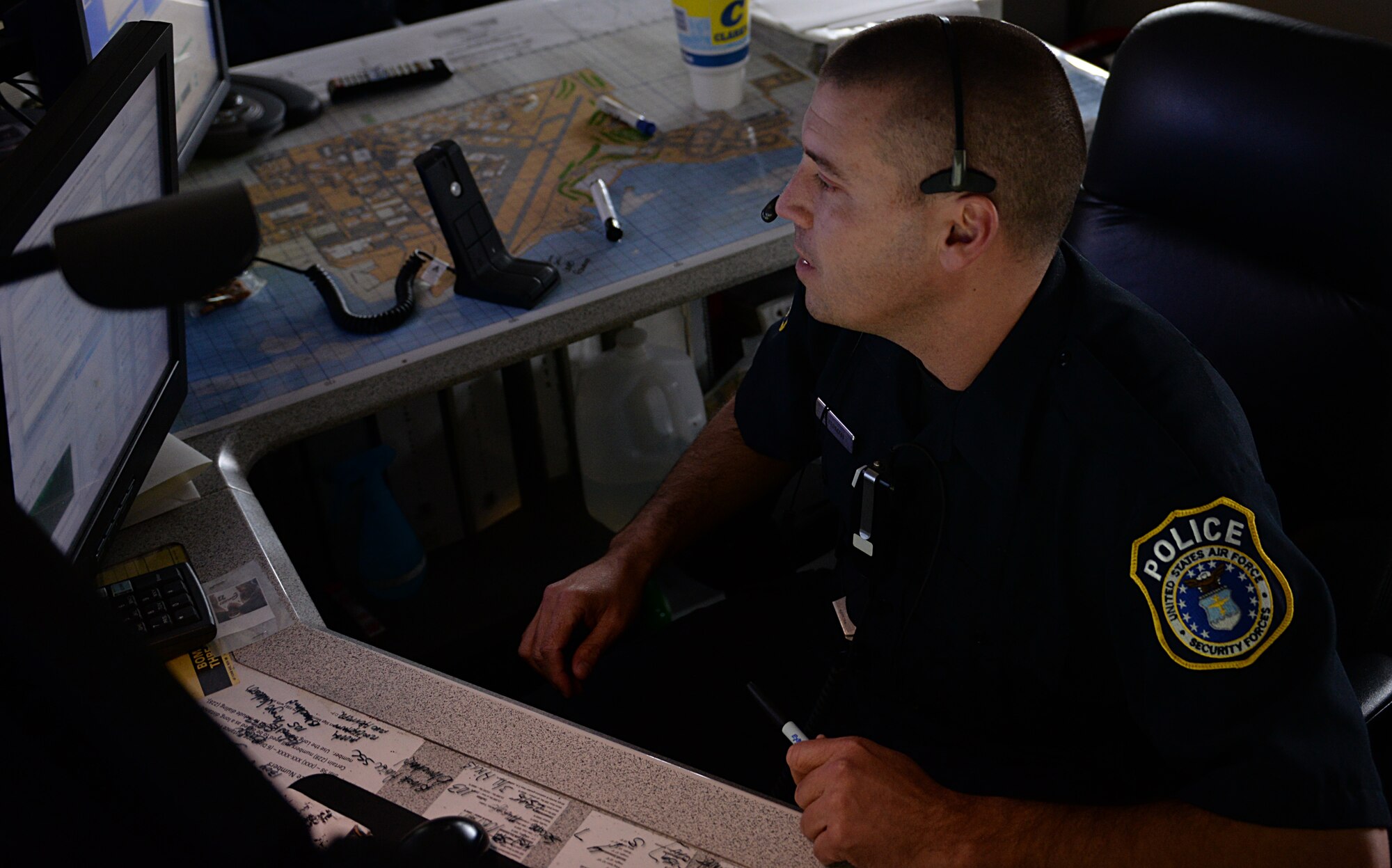 Officer Gary Peterman, 81st Security Forces alarm monitor, monitors base alarms March 12, 2015 at the base defense operations center, Keesler Air Force Base, Miss. The 81st SFS Airmen and their civilian counterparts work together by performing multiple roles to keep members of Keesler safe, ranging from checking identifications at base entrances to searching for explosives and narcotics with military working dogs. (U.S. Air Force photo by Senior Airman Holly Mansfield)