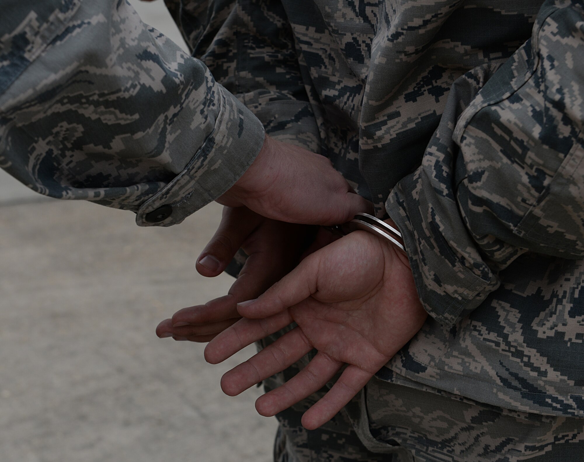 Airman 1st Class Britton Smith, 81st Security Forces internal security response team leader, simulates apprehending an Airman on the flightline March 12, 2015, Keesler Air Force Base, Miss. 81st SFS Airmen perform multiple roles to keep members of Keesler safe, ranging from identification checks at base entrances to searching for explosives and narcotics with military working dogs. (U.S. Air Force photo by Senior Airman Holly Mansfield)