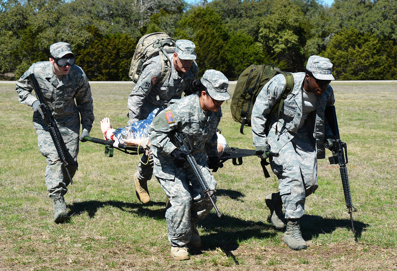 Army and Air Force personnel practice their field evacuation skills as