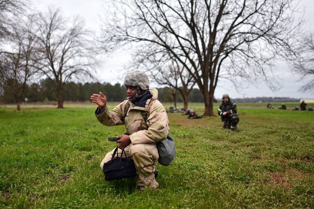 Airmen patrol through a grove of pecan trees and an open field searching for assets en route to the emergency operations center during Global Dragon Deployment in Perry, Ga., March 13, 2015.