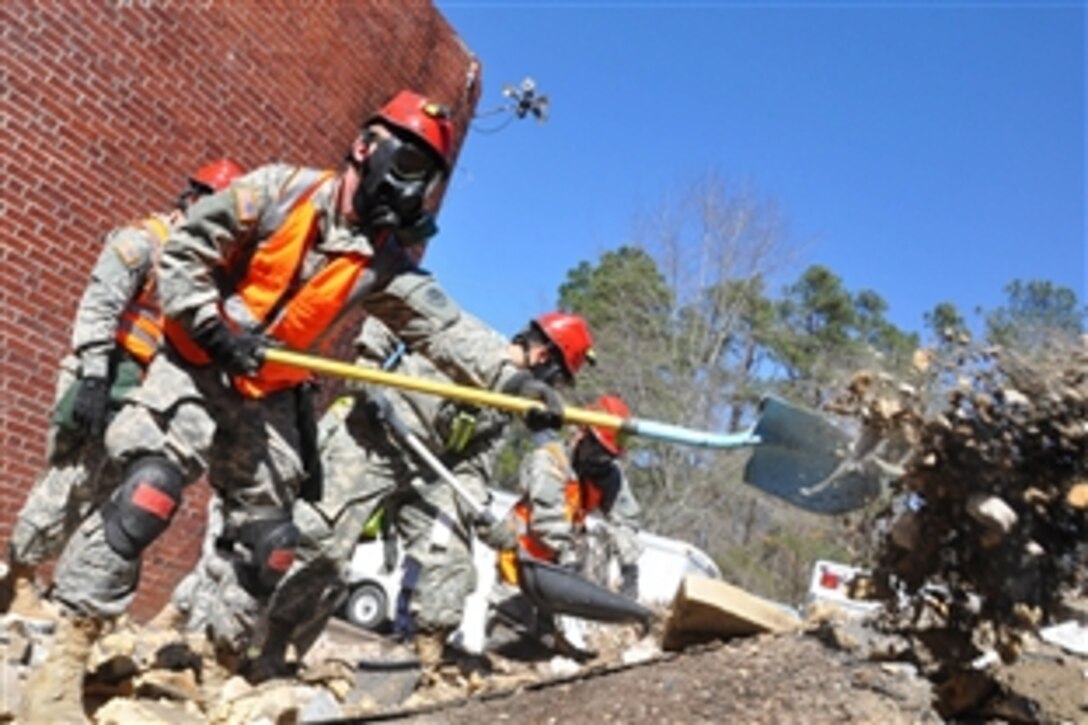 Army combat engineers clear debris from a simulated collapsed building site during Vigilant Guard in Georgetown, S.C., March 8, 2015. National Guard units worked with federal, state and local emergency management agencies and first responders to conduct the federally funded disaster-response drills. The engineers are assigned to 810th Engineer Company, Joint Task Force 781, Georgia National Guard.