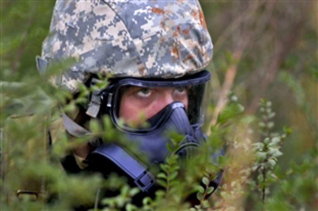 An airman reacts to sniper fire and incoming grenades while searching for assets during a training event at the Guardian Center in Perry, Ga., March 13, 2015. The exercise provides a refresher course for airmen, allowing them to use their skills to identify live chemical, biological, radiological and nuclear agents and materials.
