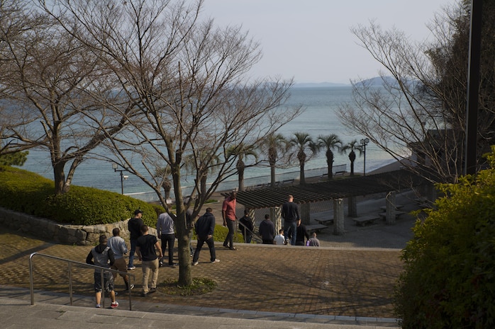 Service members with MALS-12 arrive to begin cleaning up Tsuzu Beach during a community relations event conducted by the Marine Aircraft Group 12 Chaplain's Office aboadr Marine Corps Air Station Iwakuni,Japan, March 13, 2015. Community relations events serve as an important tool in strengthening the bond between the U.S. and Japan. Major entities aboard station that conduct regular community relations events include the Marine Memorial Chapel, MAG-12 Chaplain's Office and the Single Marine Program.