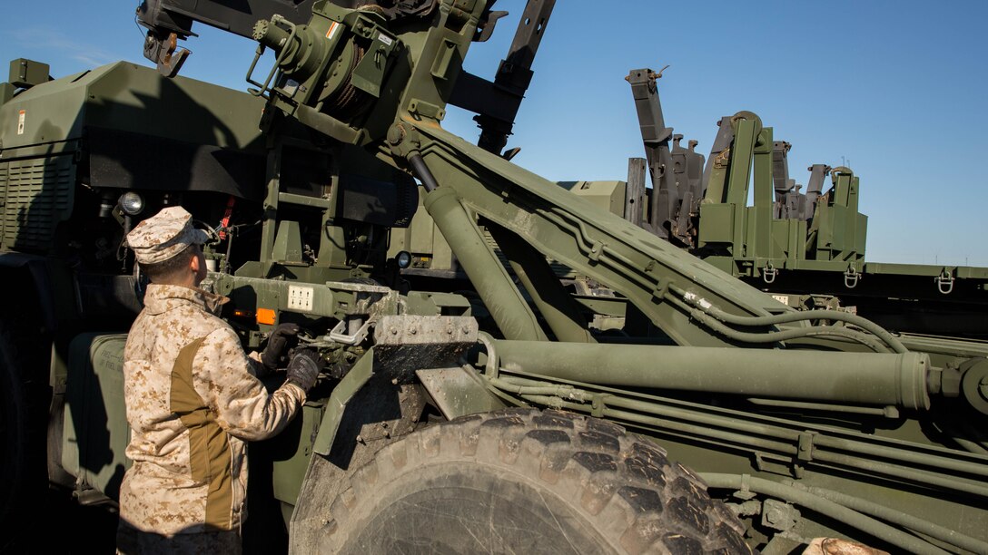 Lance Cpl. Davey R. Scarbrough, a motor vehicle operator with 8th Communication Battalion, II Marine Expeditionary Force, operates the hydraulics on the back of a Logistics Vehicle System Replacement MKR-18 Cargo during 8th Comm.’s field exercise aboard Camp Lejeune, N.C., March 12, 2015. The LVSR MKR-18 is a multi-wheeled vehicle capable of carrying storage containers on the back. 