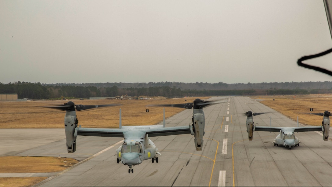 Two MV-22B Ospreys with Marine Medium Tiltrotor Squadron 261 take off from Marine Corps Air Station New River, N.C., March 3, 2015 during a division flight exercise. Three Ospreys with VMM-261 flew around the Camp Lejeune vicinity, landing in various fields to maintain readiness and current with mandatory flight certifications. 