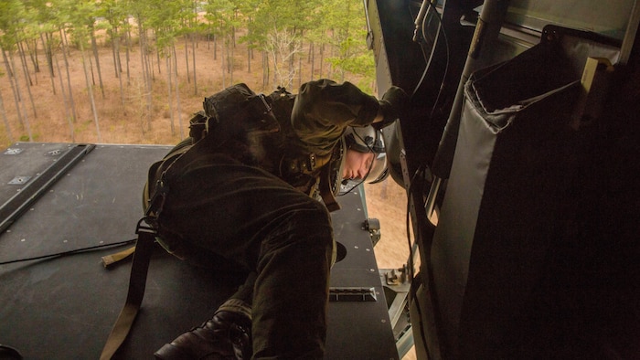 Lance Cpl. Zackary Bowen, a crew chief with Marine Medium Tiltrotor Squadron 261, scans a field for anything that could damage the MV-22B Osprey he is in while landing. As a crew chief, Bowen and another crew chief constantly monitor the aircraft’s components and make changes as necessary to ensure the safety of the crew and personnel within. 