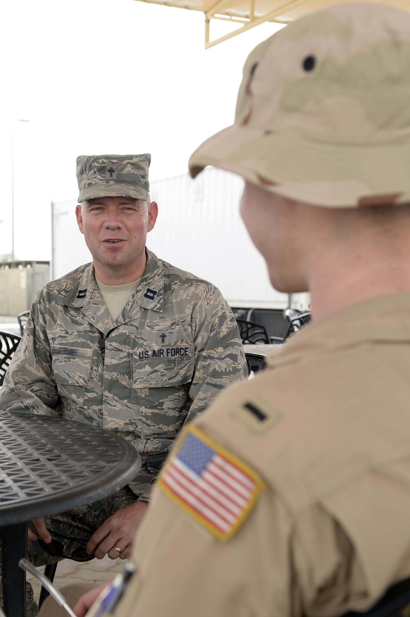 Chaplain Michael, Seven Sands Chapel, talks with an Airman at an undisclosed location in Southwest Asia Mar. 11, 2015. Unit ministries are conducted with intentional focus on the Airman through various briefings, workplace walkthroughs as well as unit activities such as awards ceremonies, barbeques and unit physical training. Michael is currently deployed from Offutt Air Force Base, Neb., and is a native of Yuma, Ariz. (U.S. Air Force photo/Tech. Sgt. Marie Brown)