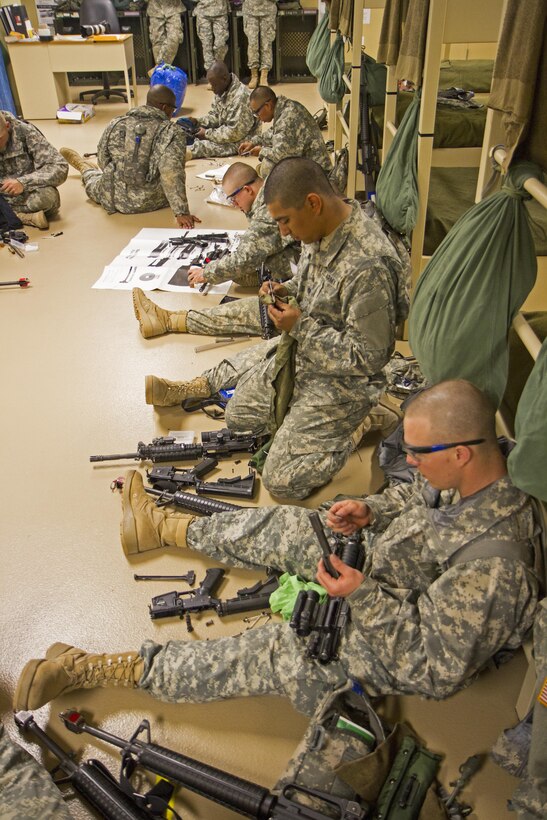 U.S. Army recruits clean their M16s in their company bay during white phase of basic combat training at Fort Jackson, S.C., March 15, 2015. (U.S. Army photo by Sgt. Ken Scar)