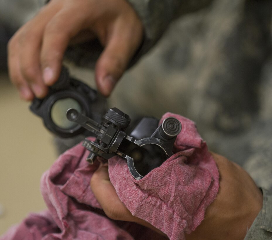 A U.S. Army recruit cleans his M16 in a company bay during basic combat training at Fort Jackson, S.C., March 15, 2015. (U.S. Army photo by Sgt. Ken Scar)