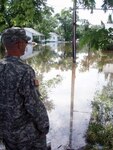 Army Sgt. Bernard Friend of the Missouri National Guard provides security to evacuated homes in Louisiana, Mo., June 22, 2010. Missouri National Guard Soldiers and Airmen are working with state and local agencies to provide security and help with flood relief operations.