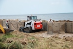 The Louisiana National Guard’s 225th Engineer Brigade construct a wall of sand-filled Hesco Concertainer units in Cameron, La., to help keep oil-tainted water in the Gulf of Mexico from moving inland, June 22 2010.