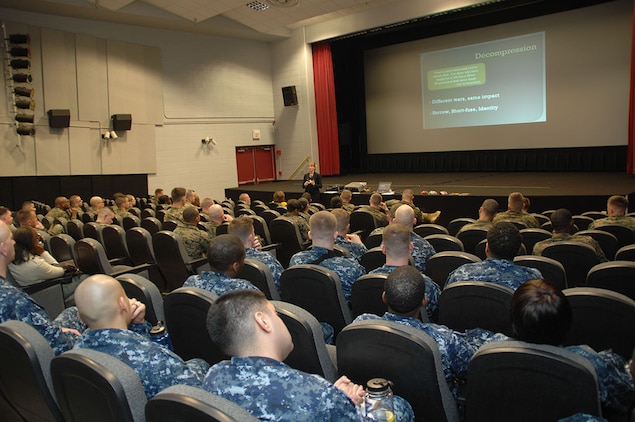Dr. Tracy Hejmanowski, psychologist, Naval Hospital Jacksonville, Fla., briefs Marines and Sailors aboard Marine Corps Logistics Base Albany on the symptoms of combat and operational stress, recently.