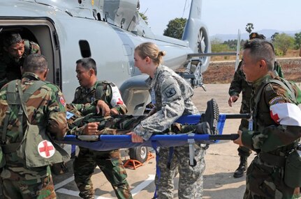 Soldiers from the Royal Cambodian Armed Forces (left), assist Spc. Miykala Fritz, a medic from the Idaho Army National Guard, in moving a simulated patient on a stretcher into a medical evacuation helicopter. The training is part of a first responder course which is held at the Peacekeeping Operations Center in Kampong Speu Province, Cambodia, and taught by IDARNG Soldiers. The first responder course will teach the RCAF lifesaving skills and techniques by using a combination of classroom lessons, hands on practice and a proper response techniques they would need during humanitarian assistance / disaster response operations. (U.S. Army photo by Staff Sgt. Chris McCullough, U.S. Army Pacific Public Affairs)