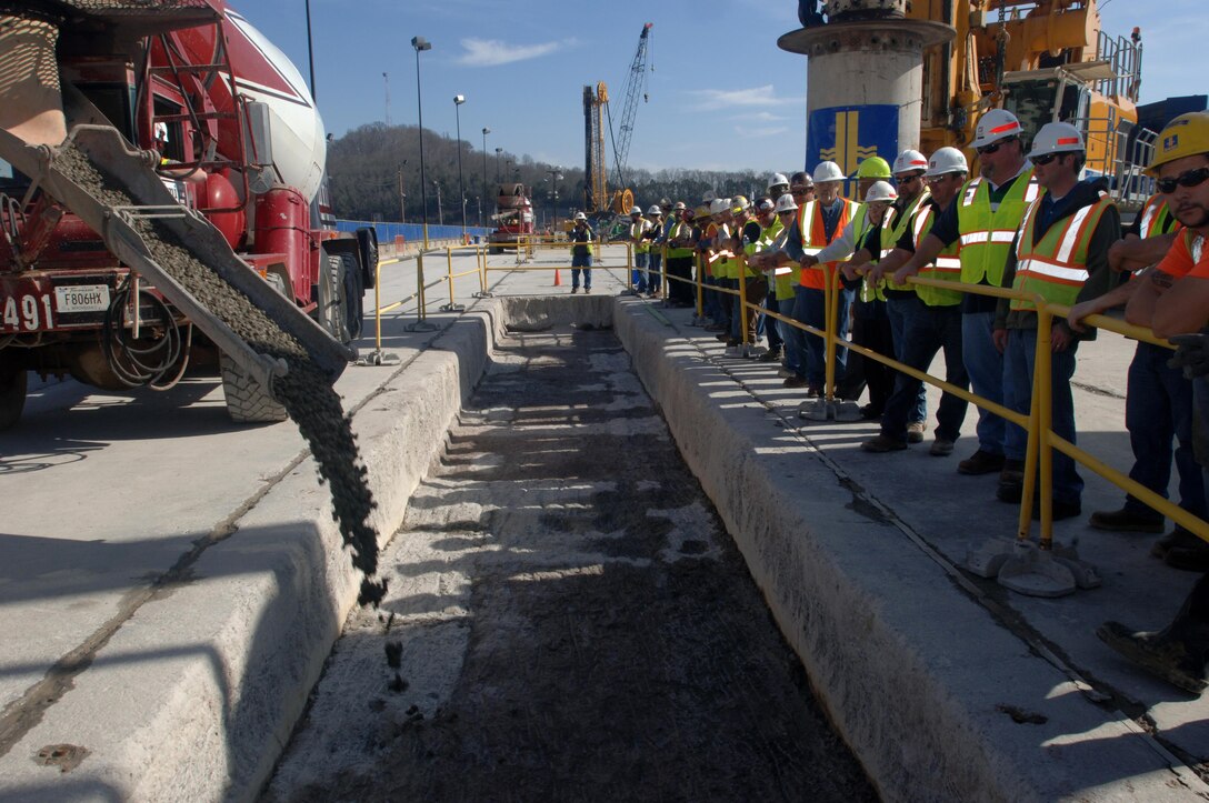 Members of the U.S. Army Corps of Engineers Nashville District and Bauer Foundation Corporation line up March 17, 2015 to watch the last concrete placement of the Center Hill Dam Remediation Project at Lancaster, Tenn. The Corps of Engineers and its Contractor Bauer Foundation Corporation installed a 2.5-feet thick concrete barrier wall vertically along the embankment in overlapping rectangular columns as deep as 308 feet from the top of the dam deep into the solid-rock foundation.  The placement completes the $115 million foundation barrier wall project that began July 11, 2012. Enough concrete was placed into the embankment to build a four-foot wide sidewalk 200 miles or about the distance between Nashville and Knoxville in Tennessee.