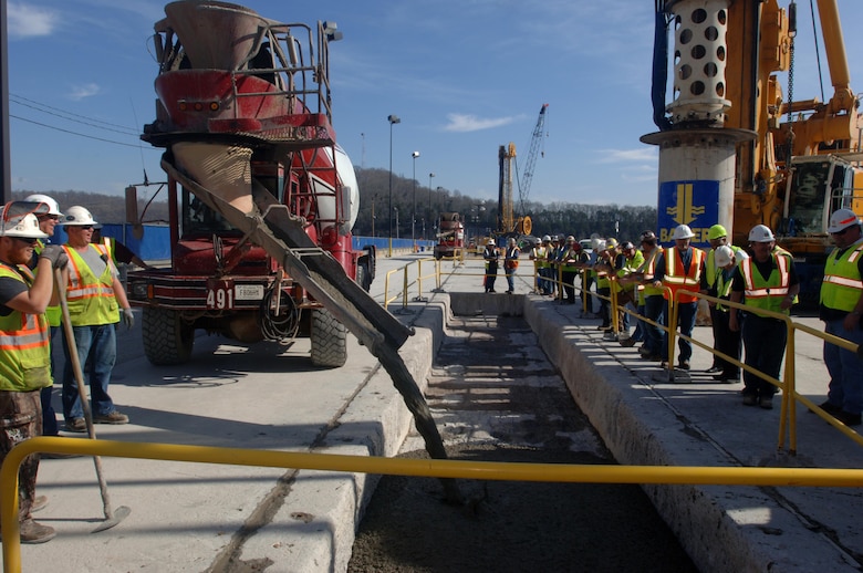 Members of the U.S. Army Corps of Engineers Nashville District and Bauer Foundation Corporation line up March 17, 2015 to watch the last concrete placement of the Center Hill Dam Remediation Project at Lancaster, Tenn. The Corps of Engineers and its Contractor Bauer Foundation Corporation installed a 2.5-feet thick concrete barrier wall vertically along the embankment in overlapping rectangular columns as deep as 308 feet from the top of the dam deep into the solid-rock foundation.  The placement completes the $115 million foundation barrier wall project that began July 11, 2012. Enough concrete was placed into the embankment to build a four-foot wide sidewalk 200 miles or about the distance between Nashville and Knoxville in Tennessee. 