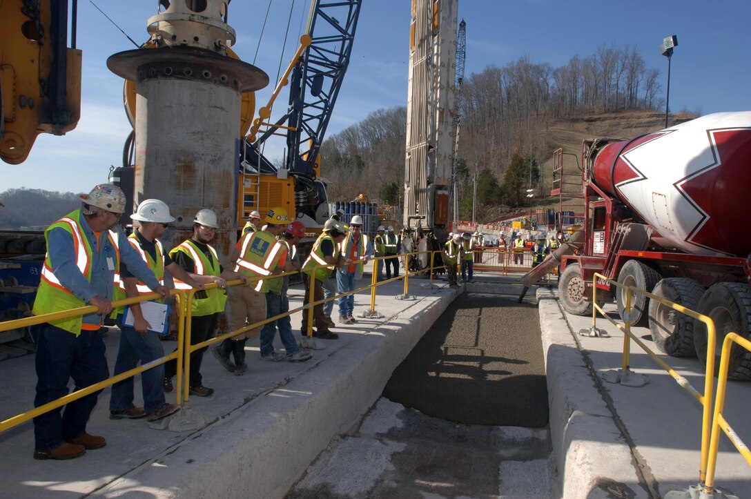 Members of the U.S. Army Corps of Engineers Nashville District and Bauer Foundation Corporation line up March 17, 2015 to watch the last concrete placement of the Center Hill Dam Remediation Project at Lancaster, Tenn. The Corps of Engineers and its Contractor Bauer Foundation Corporation installed a 2.5-feet thick concrete barrier wall vertically along the embankment in overlapping rectangular columns as deep as 308 feet from the top of the dam deep into the solid-rock foundation.  The placement completes the $115 million foundation barrier wall project that began July 11, 2012. Enough concrete was placed into the embankment to build a four-foot wide sidewalk 200 miles or about the distance between Nashville and Knoxville in Tennessee. 