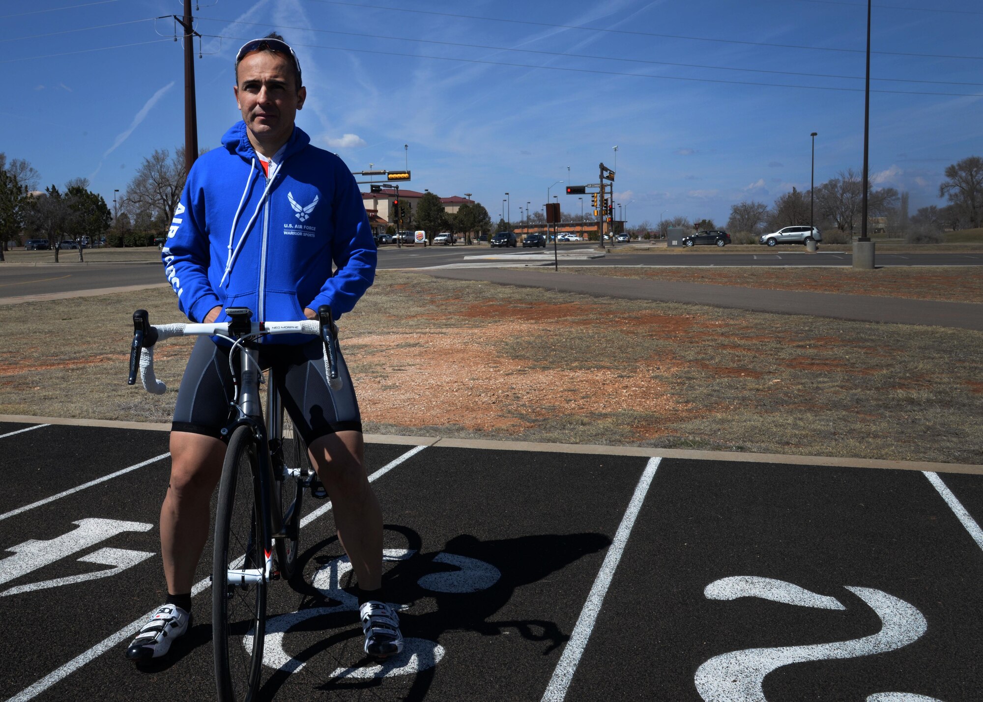 U.S. Air Force Maj. Joseph Williams, 27th Special Operations Medical Operations Squadron clinical medicine flight commander, poses on his bicycle at the base track March 13, 2015 at Cannon Air Force Base, N.M. Williams has found a way to mesh his profession with his passion through the Air Force Wounded Warrior Program, an organization dedicated to ensuring Airmen receive professional support and care from any point of injury, through separation or retirement, for life. (U.S. Air Force photo/Staff Sgt. Alex Mercer)