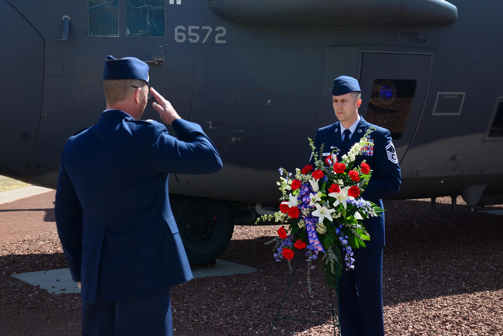 U.S. Air Force Lt. Col. Andrew Koegl, 16th Special Operations Squadron commander, renders a salute to a wreath memorializing the Air Commandos during a Jockey 14 memorial March 13, 2015 at Cannon Air Force Base, N.M. Koegl presided over a memorial ceremony that recalled Jockey 14’s tragic crash off the coast of Kenya in March 1994. (U.S. Air Force photo/Airman 1st Class Shelby Kay-Fantozzi)