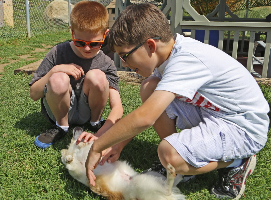 Brennon and Christopher Weaver play with puppies during the St. Patrick’s Day Lucky Adoption Event, March 14 at the Camp Pendleton Animal Shelter. With events like the St. Patrick’s Day Lucky Adoption Event, the base shelter hopes to promote pet adoption by reducing normal adoption fees from $110 for dogs and $85 for cats to a cheaper amount which the adopters randomly draw from a hat. The fees are inclusive of neutering, a rabies vaccine, tracking microchip, a distemper vaccine and flea control.