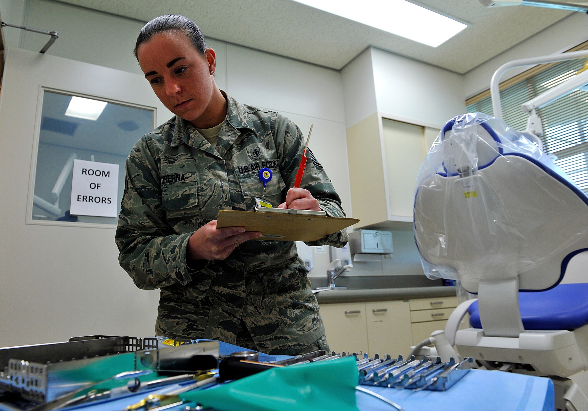 U.S. Air Force Staff Sgt. Brittney Diperna, 18th Dental Squadron dental technician, inspects a simulated room for discrepancies during the National Patient Safety Awareness Week on Kadena Air Base, Japan, March 11, 2015. Each year, health care organizations around the globe take part in the event by raising awareness in the community and utilizing National Patient Safety foundation resources to educate hospital staff and patients. (U.S. Air Force photo by Naoto Anazawa)
