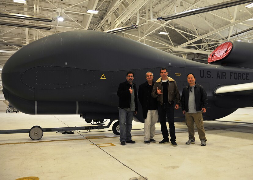 (From left to right) Danny Villalpando, Gary Brightwell, Graham Elwood and Paul Ogata pose in front of a Block 40 RQ-4 Global Hawk during a tour of Grand Forks Air Force Base, N.D., March 13, 2015. The four comedians were given a tour to see what the men and women of Grand Forks AFB do before their appearance in the Comics on Duty Tour at the Northern Lights Club. (U.S. Air Force photo/Senior Airman Xavier Navarro)