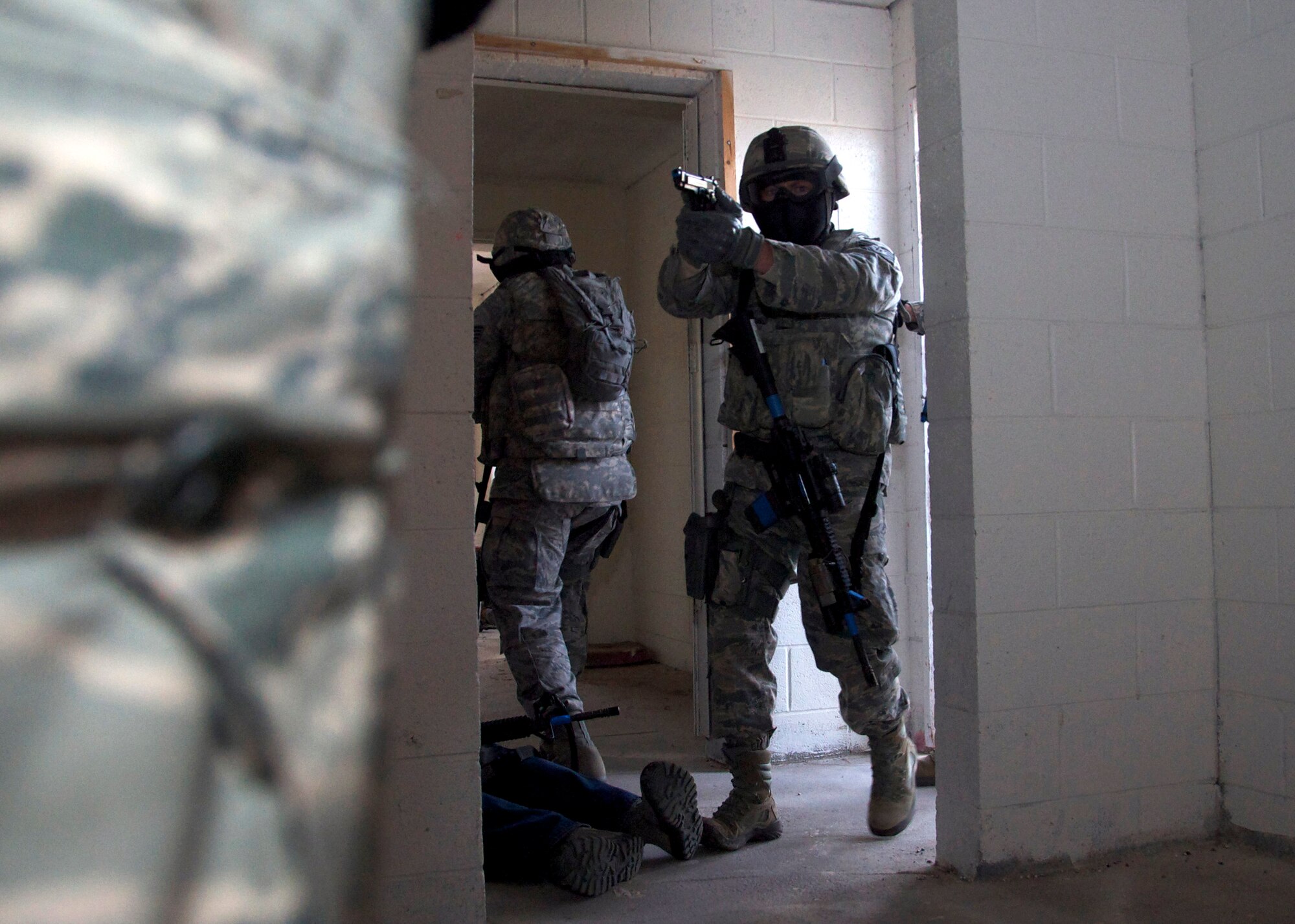 Tech. Sgt. Nathan Yeaman, 419th Security Forces Squadron, enters a building ready to subdue enemy targets, while communicating with his team and working around the training observers with precision. More than 50 reservists from the 419th Fighter Wing participated in the four-day training exercise at Camp Williams March 11-14. (U.S. Air Force photo/Staff Sgt. Crystal Charriere)