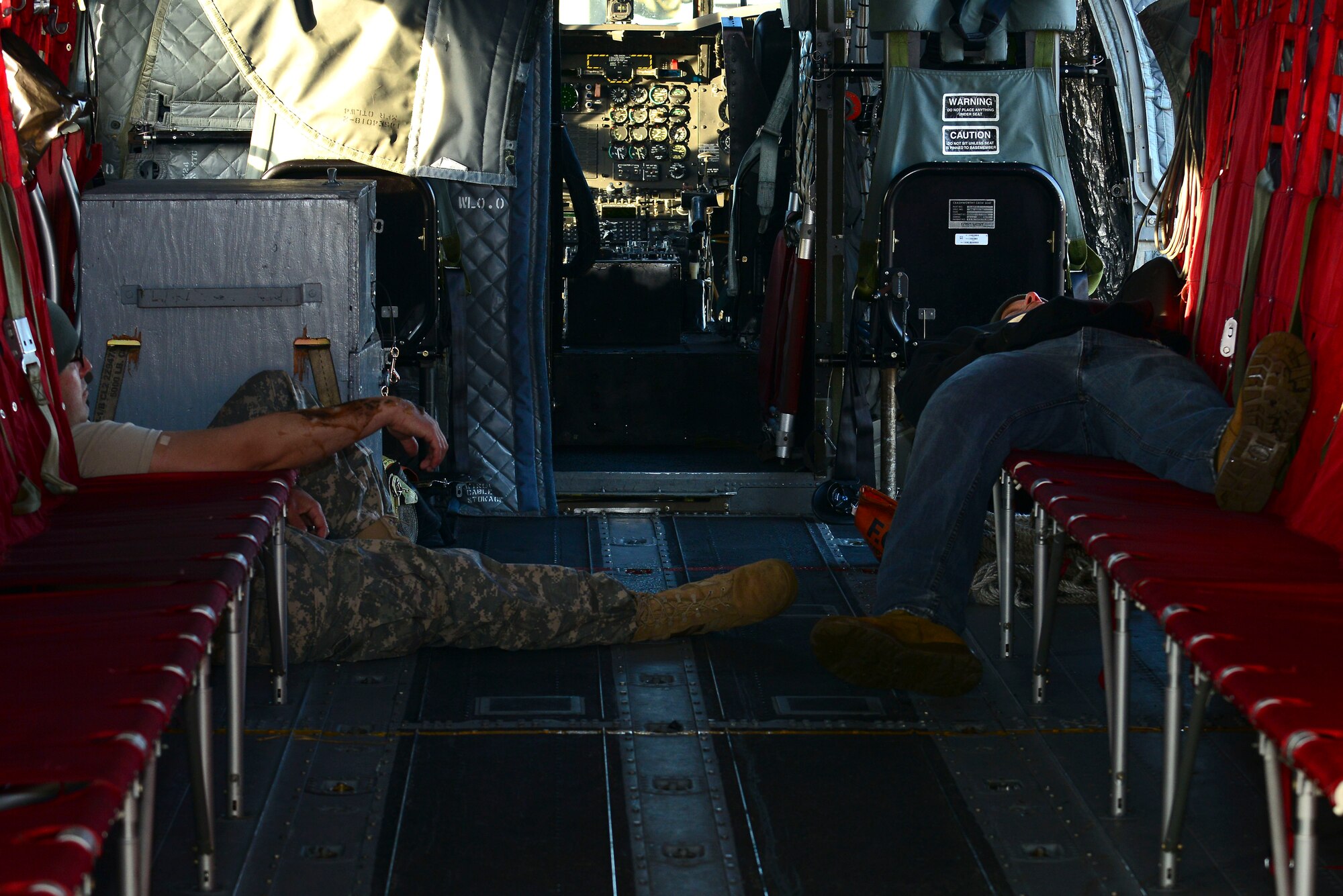 Two simulated casualties lay inside of the aircraft used during a full-scale helicopter crash exercise at Fort Eustis, Va., March 13, 2015. One critically injured member was taken in a medical helicopter while the others were sent to nearby hospitals with minor injuries. (U.S. Air Force photo by Senior Airman Kimberly Nagle/Released)