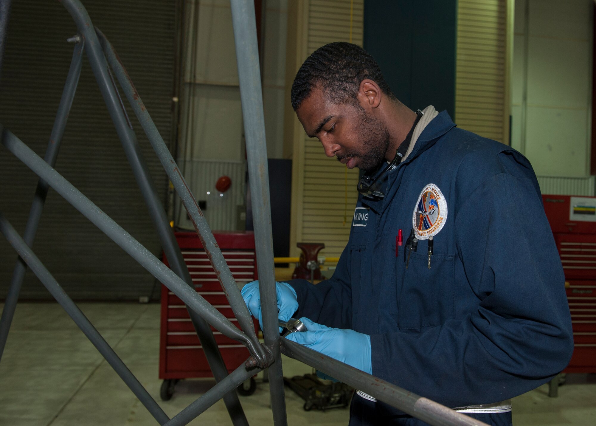 Airman 1st Class Tyrell King, 436th Maintenance Squadron Aerospace Ground Equipment, performs maintenance on a B-5 Maintenance Stand March 17, 2015, at Dover Air Force Base, Del. King is one of only 24 personnel that maintenances more than 400 pieces of equipment. (U.S. Air Force photo/Airman 1st Class Zachary Cacicia)