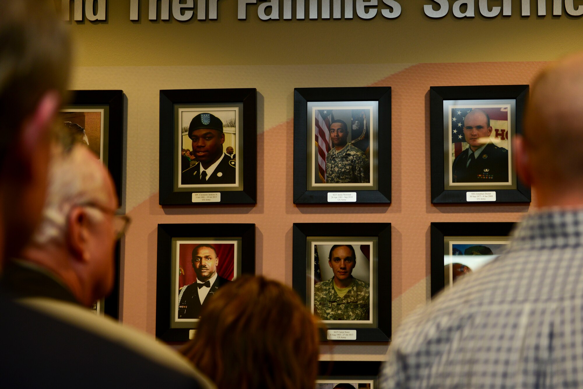 Gold Star Family members observe the Wall of Remembrance after an unveiling ceremony at Fort Eustis, Va., March 13, 2015. Gold Star Families are surviving relatives of fallen Service members. The wall depicts more than 50 Service members and their families who are a part of the Fort Eustis Survivor Outreach Services. (U.S. Air Force photo by Senior Airman Kimberly Nagle/Released)


